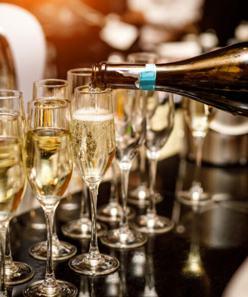 Waiter filling a glass of champagne in a restaurant. Waiter filling a glass of champagne in a restaurant
